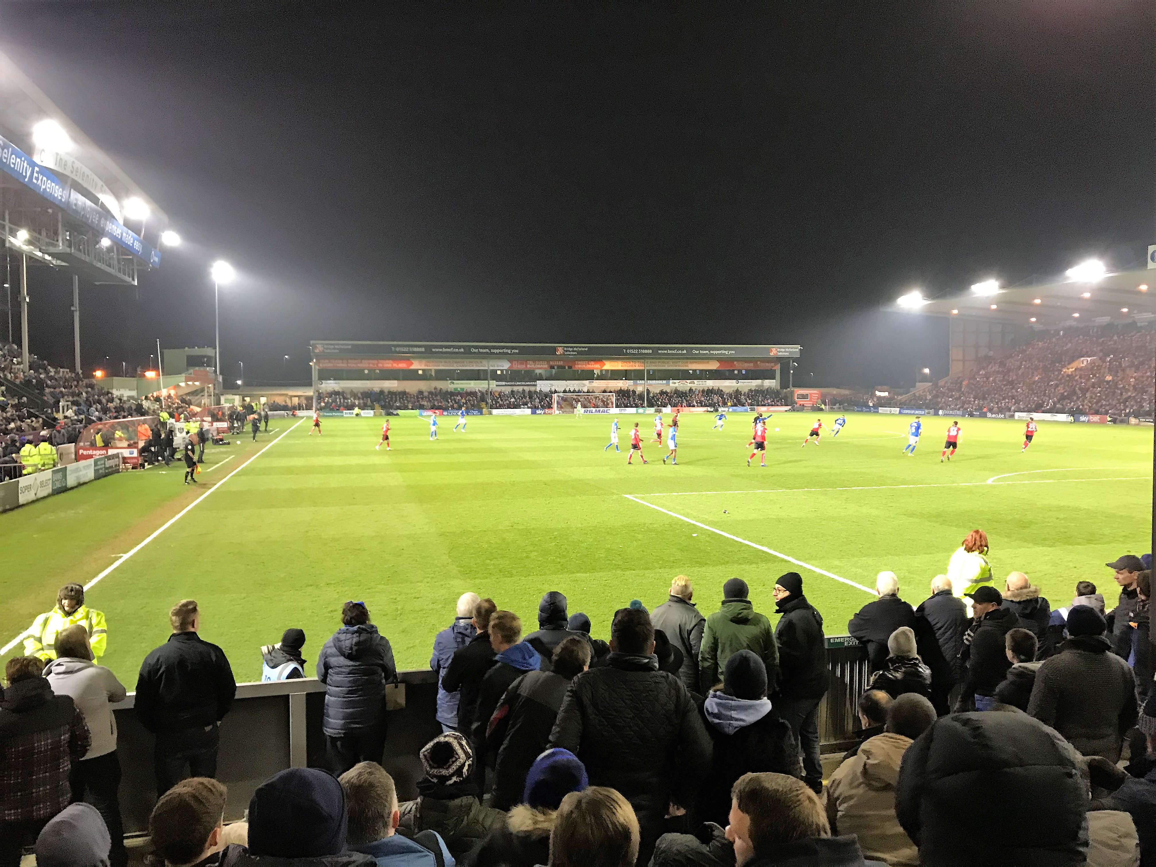 Floodlit football match in a UK stadium